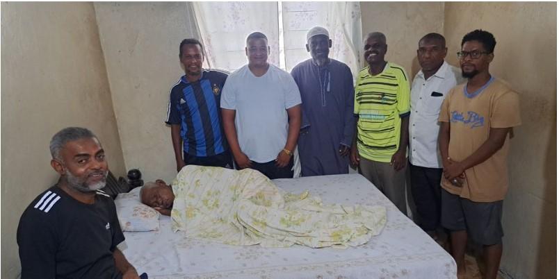 Former Mombasa Combined players pay a visit to Ahmed Breik (lying in bed) at his house in Majengo, Mombasa on August 8, 2023. Breik passed away on Monday after long illness.