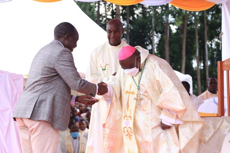 Kisii Governor Simba Arati and Catholic Bishop Joseph Mairura during mass at Nyansakia Catholic Church on January 13, 2024.