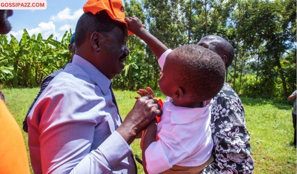 ODM leader Raila Odinga is helped to wear his ODM cap by a baby when he landed in Meru on February 3, 2024.