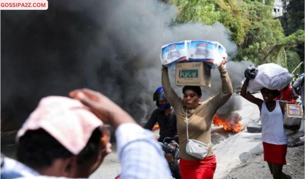 People react as they walk near a burning barricade set up in protest against the government and calling for the resignation of Prime Minister Ariel Henry, in Port-au-Prince, Haiti February 5, 2024.