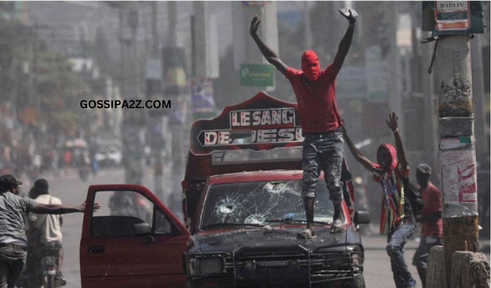 A masked man calls on demonstrators to stop during a protest against Prime Minister Ariel Henry's government and insecurity, in Port-au-Prince, Haiti March 1, 2024.