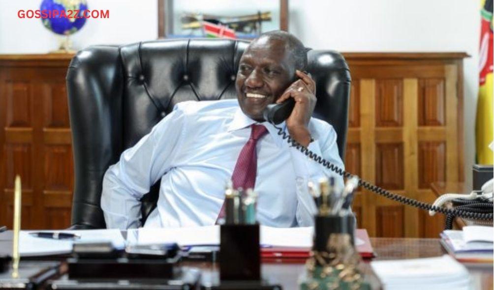 President William Ruto smiling while on call in his office.