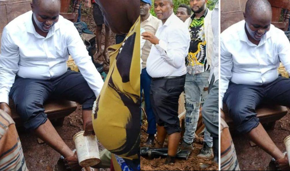 Mathioya residents washing off the mud from MPs after visiting from them at Ngutu Primary School where they were being sheltered after a mudslide swept away their homes.