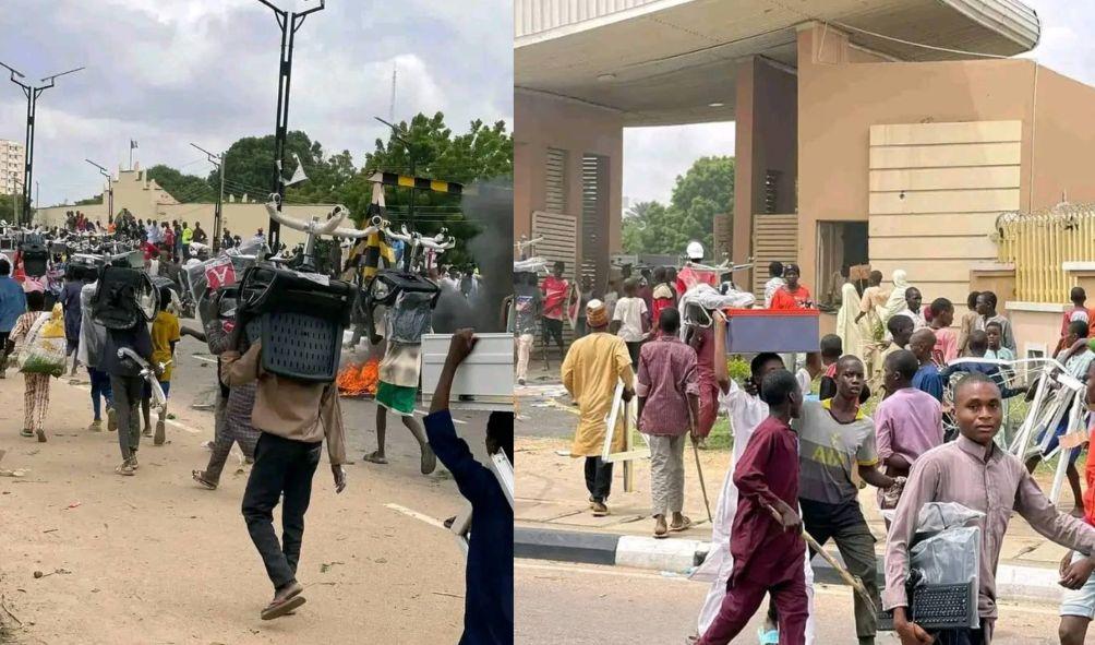 Protestors are seen vandalizing and looting a shop in Kano State