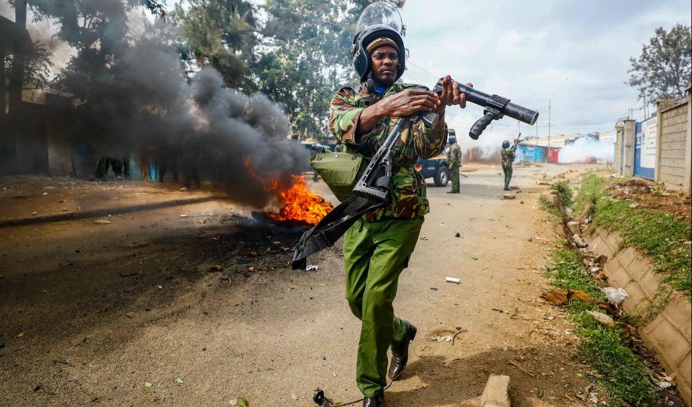 A riot policeman reloads a teargas grenade launcher during clashes with protesters in the Kibera area of Nairobi, Kenya Wednesday, July 19, 2023.