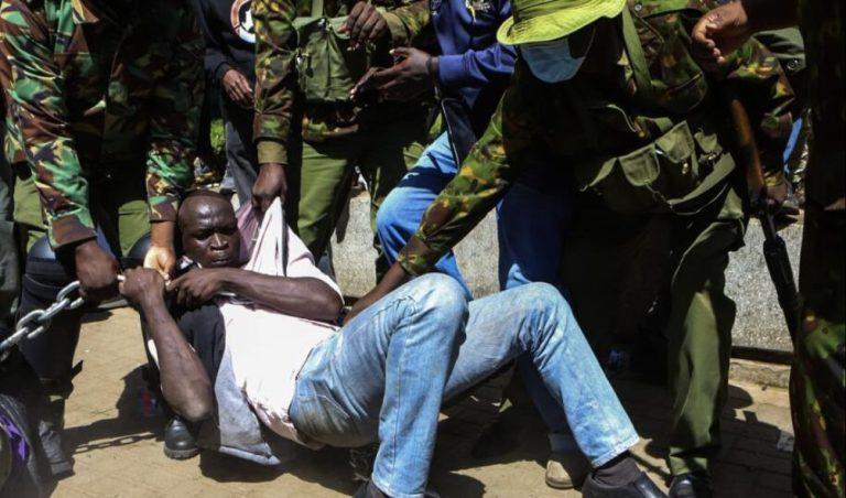 Anti-riot officers arrest a protestor in Nairobi on Dec 2024