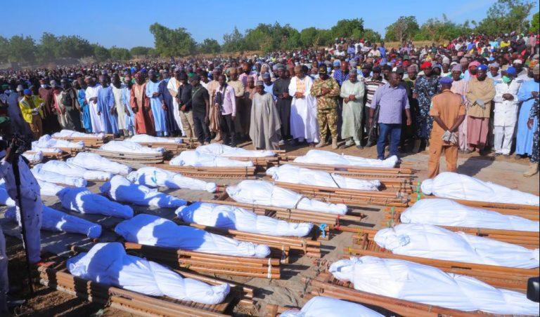 People attend a funeral for those killed by suspected Boko Haram militants in Zaabarmar, Nigeria, Sunday, Nov. 29, 2020. Nigerian officials say suspected members of the Islamic militant group Boko Haram have killed at least 40 rice farmers and fishermen while they were harvesting crops in northern Borno State. The attack was staged Saturday in a rice field in Garin Kwashebe, a Borno community known for rice farming. (AP Photo/Jossy Ola)