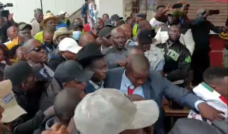 Rigathi Gachagua being escorted past a crowd after arriving at the Jomo Kenyatta International Airport (JKIA) on August 21, 2025.